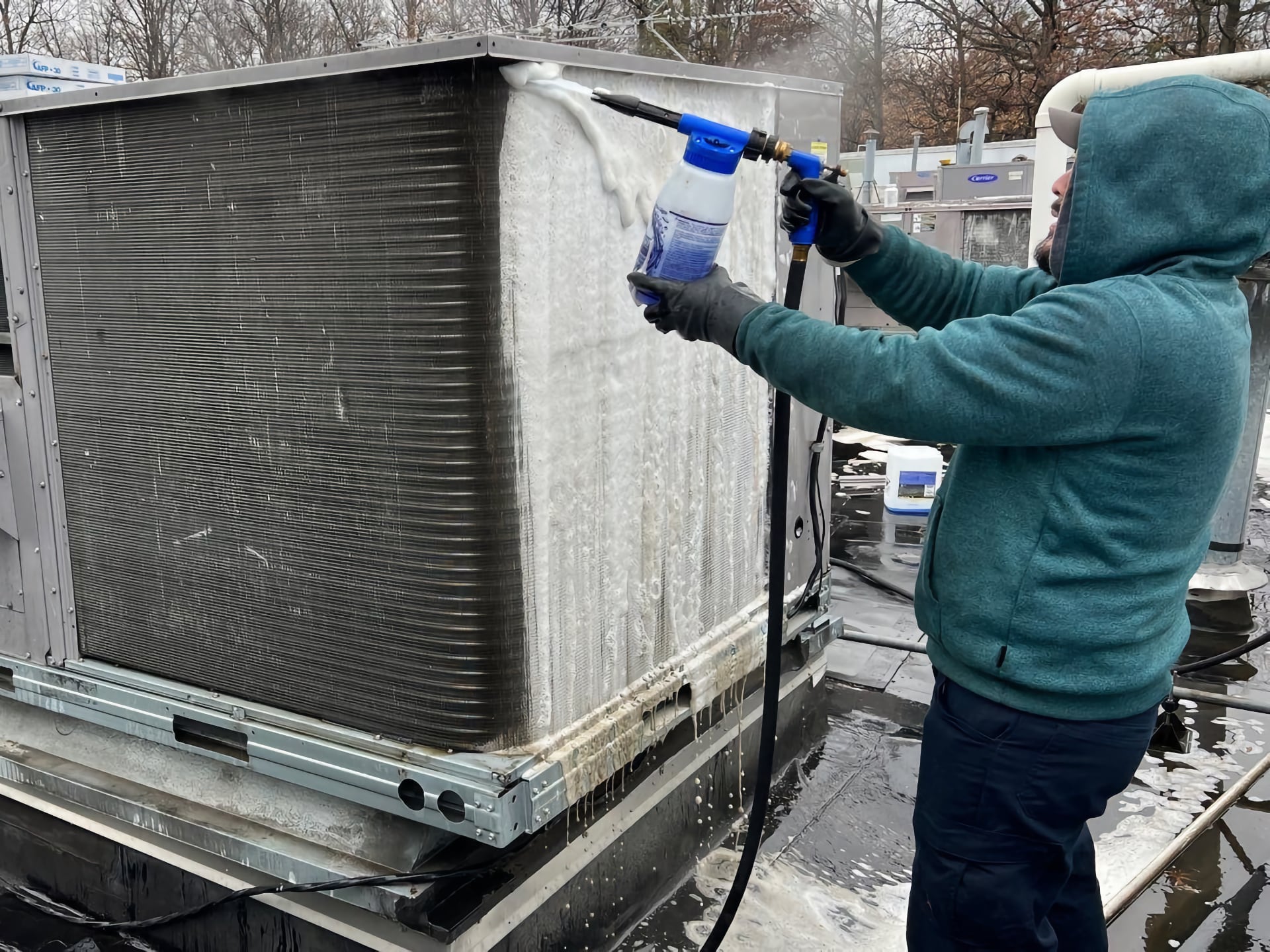 Man cleaning outside HVAC heatpump